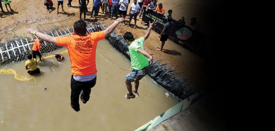 A warrior leaping from the truck into the water pit at Cliff Jump